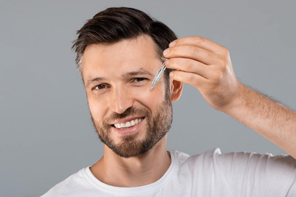 Man applying face serum for Low T skincare