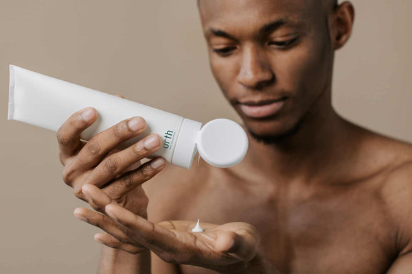 black man applying urth men's skincare products