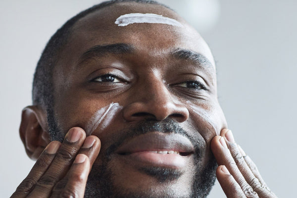 black man applying urth men's moisturizer