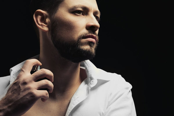 man spraying urth men's perfume
