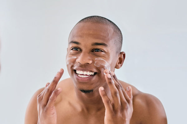 black man washing face with urth's men's face wash