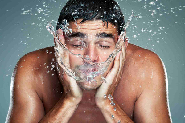 handsome man splashing water on face, urth