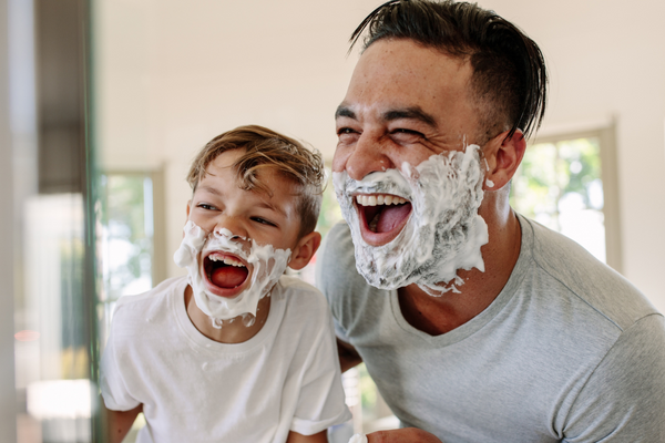 dad and young son with shaving cream for men on face, urth 