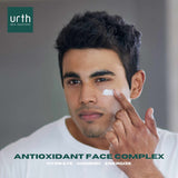 latino young man applying urth's men's moisturizer to face